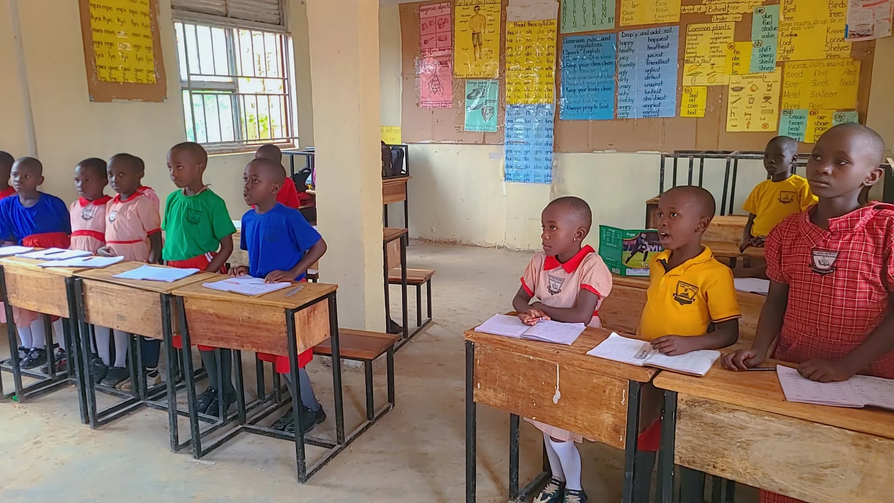 St. Keren Junior School pupils standing at their desks and taking part in a classroom lesson