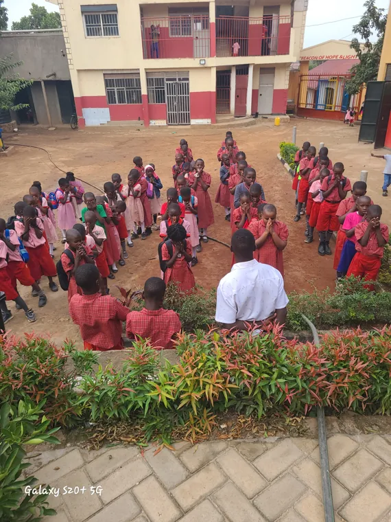 The school community assembled in the courtyard